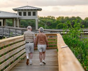 older couple walking on dock